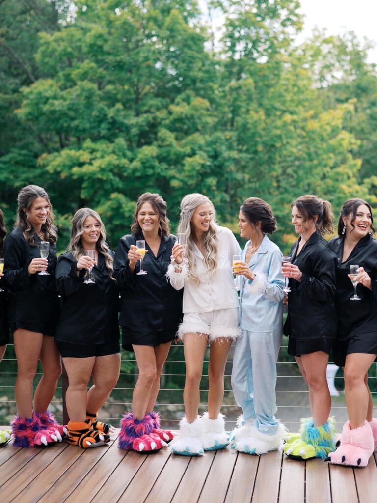 a bride and her bridesmaids in their getting ready outfits on the bear ridge balconies